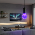 Smart LED bulb emitting vibrant color-changing light in a modern living room